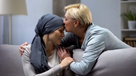 Woman comforting cancer patient